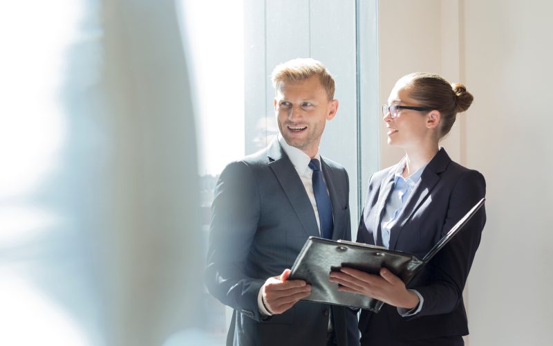 Businessman and businesswoman preparing for meeting